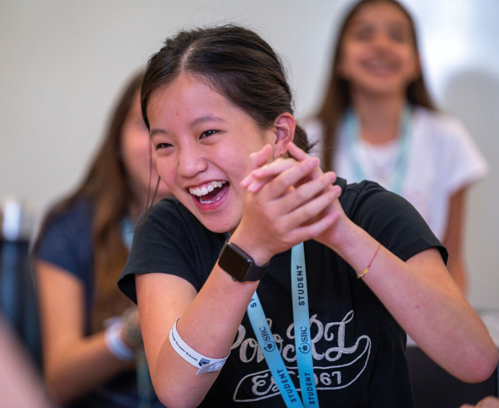 SBC-Eton-College-business-course-student-laughing-and-clapping