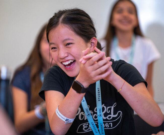 SBC-Eton-College-business-course-student-laughing-and-clapping