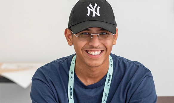 Smiling-pupil-of-SBC-Headington-Summer-School-wearing-cap