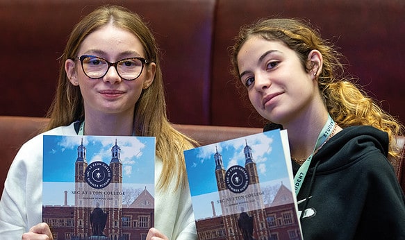Two-Female-Students-holding-report-folders-at-SBC-at-Eton-College-Summer-School