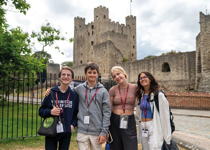 Summer-boarding-courses-students-stood-outside-historic-building-uk