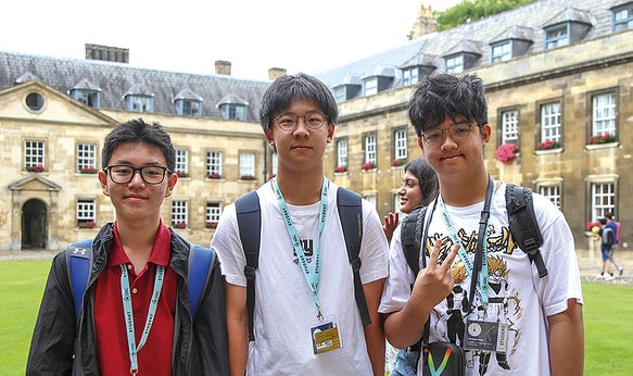 three-SBC-Cambridge-college-students-smiling-outside-uk-building