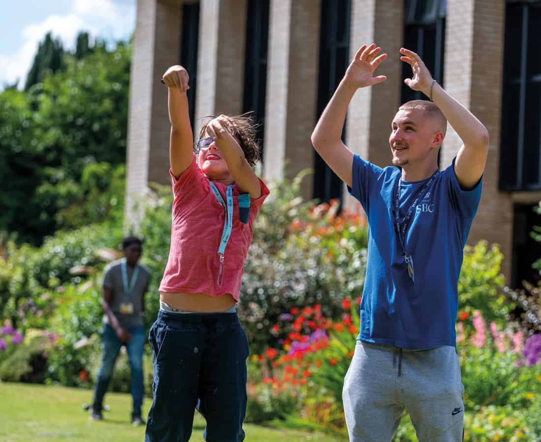 Our Activity Leader outside with students playing and having fun with SBC students