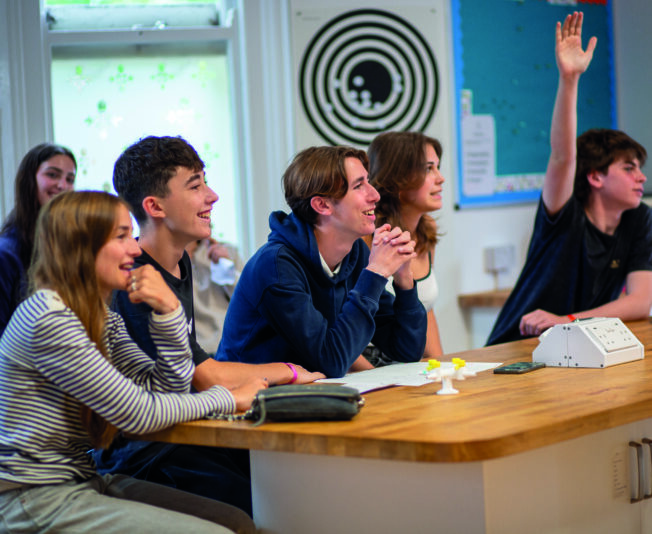 Engaging students participating in summer boarding courses classroom activity.