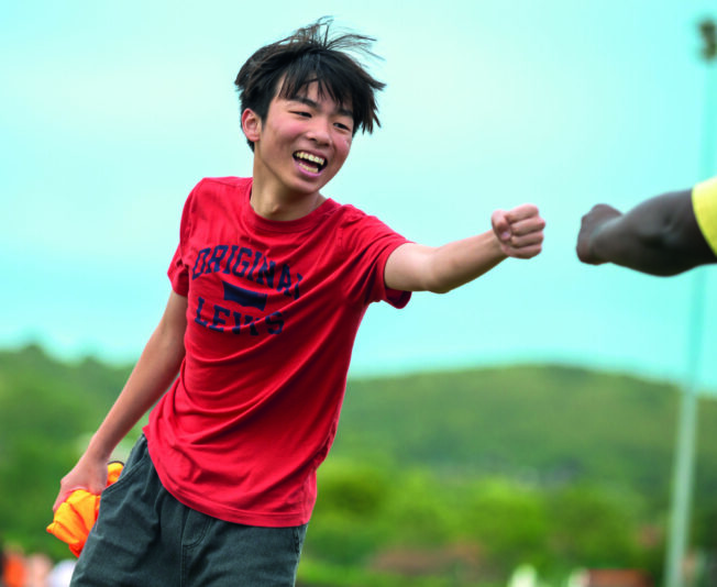 Vibrant image of a young boy enjoying summer sports at a summer boarding course outdoor activity.