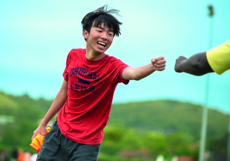 Vibrant image of a young boy enjoying summer sports at a summer boarding course outdoor activity.