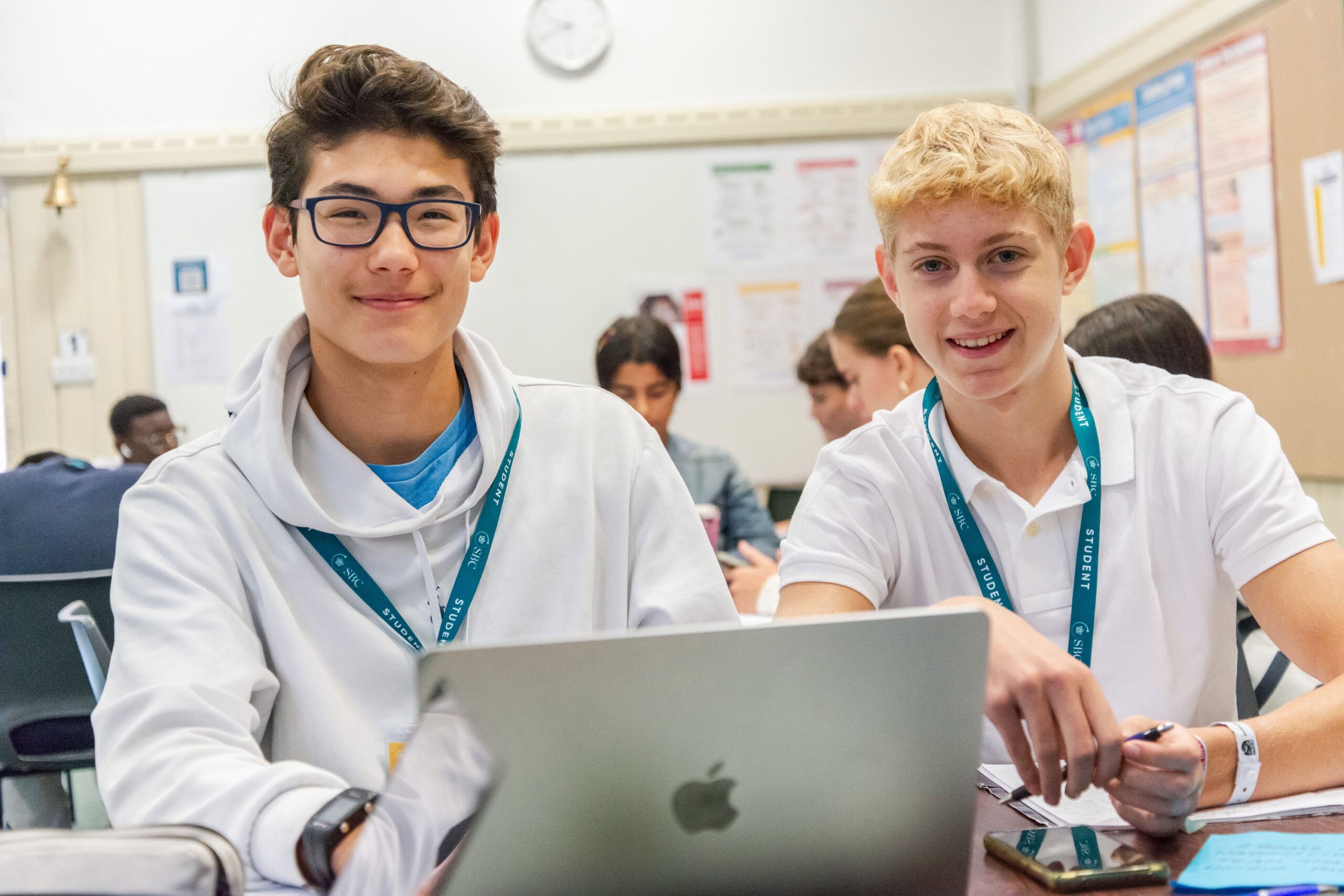 Young students engaging in summer boarding courses at an international school in a classroom setting, learning and exploring new skills.
