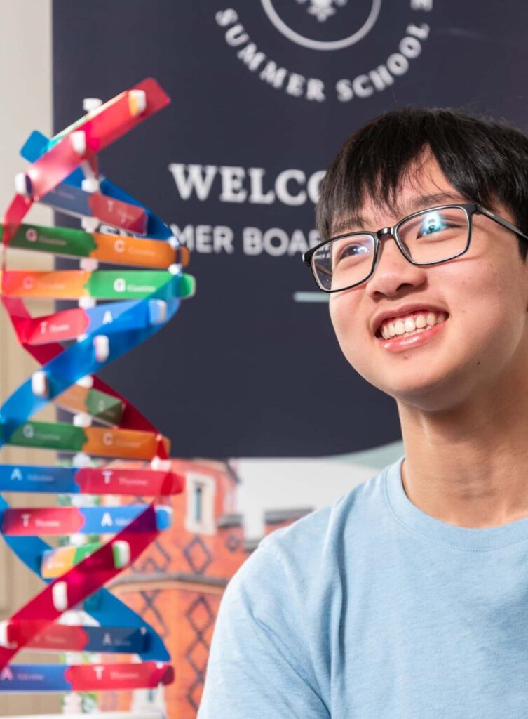 Colourful DNA model at summer boarding courses, engaging science activity for students.