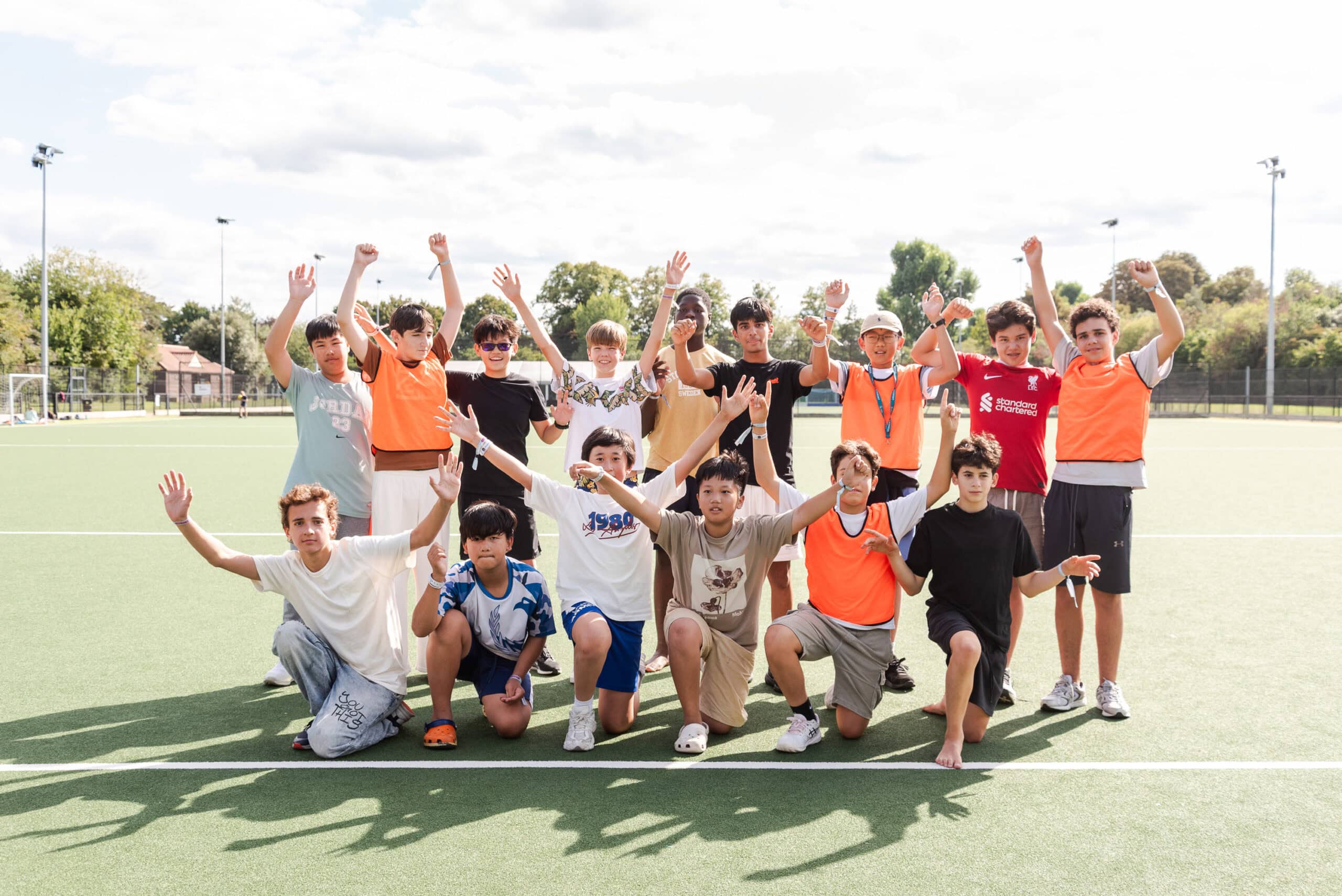group of children playing rugby on a sports field during summer boarding courses in the UK