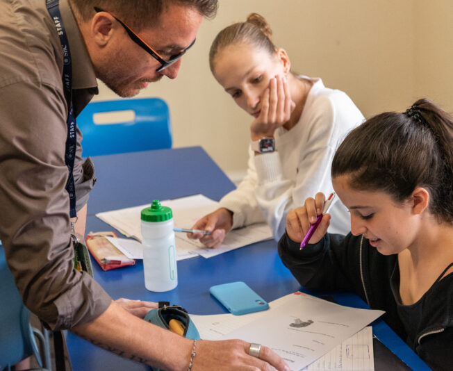 Teacher supporting two students at Earlscliffe
